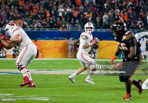 University of Wisconsin Badgers quarter back Alex Hornibrook drops back to pass as the Badgers compete against the University of Miami Hurricanes...