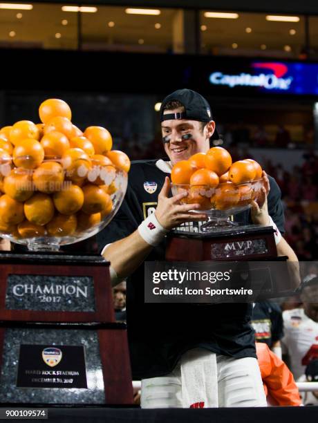 University of Wisconsin Badgers quarter back Alex Hornibrook celebrates with the MVP Trophy as the Badgers defeated the University of Miami...