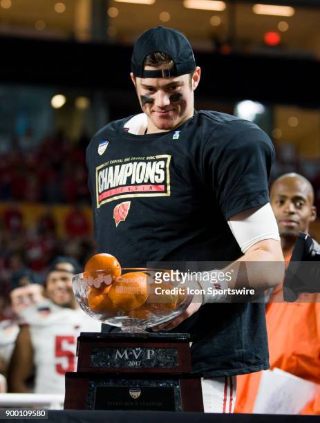 University of Wisconsin Badgers quarter back Alex Hornibrook celebrates with the MVP Trophy as the Badgers defeated the University of Miami...