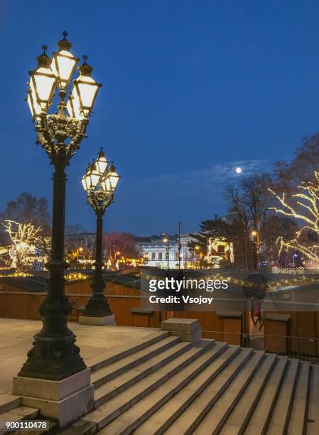 clear sky with moonlight at rathauspark, vienna, austria - decorated christmas trees outside stockfoto's en -beelden