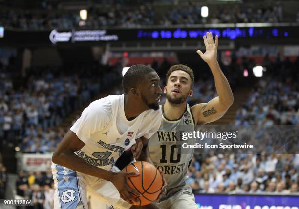 North Carolina Tar Heels guard Brandon Robinson looks up at the basket while Wake Forest Demon Deacons guard Mitchell Wilbekin guards him during the...