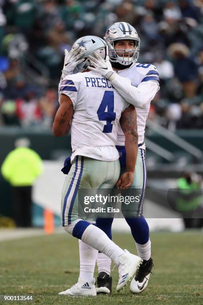 Quarterback Dak Prescott of the Dallas Cowboys celebrates a touchdown by a teammate with tight end Geoff Swaim against the Philadelphia Eagles during...