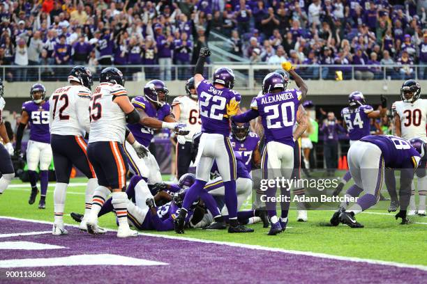 Harrison Smith and Mackensie Alexander of the Minnesota Vikings signal fourth down after holding the Chicago Bears on the goal line in the fourth...