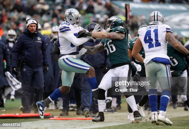 Wide receiver Dez Bryant of the Dallas Cowboys is pushed out of bounds by defensive end Chris Long of the Philadelphia Eagles during the second half...