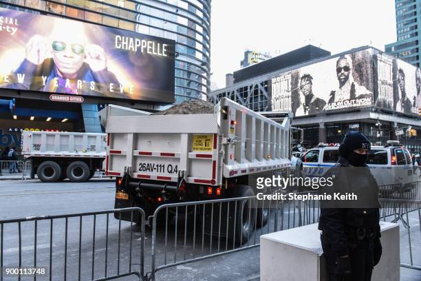 Sanitation trucks filled with sand block access to 42nd street in Times Square ahead of the New Year's Eve celebration on December 31, 2017 in New...