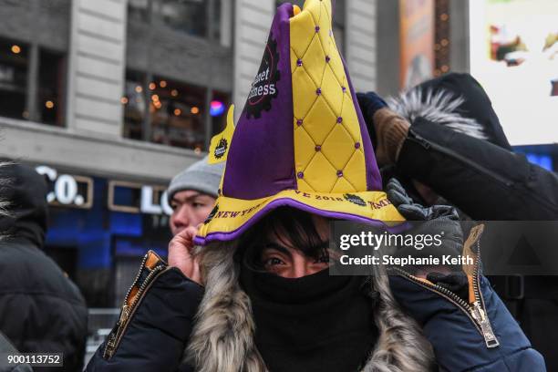 Spectators put on their party hats in Times Square ahead of the New Year's Eve celebration on December 31, 2017 in New York City.