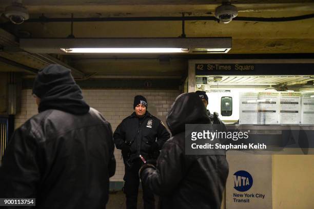 Members of the New York City police department patrol the subway in Times Square ahead of the New Year's Eve celebration on December 31, 2017 in New...