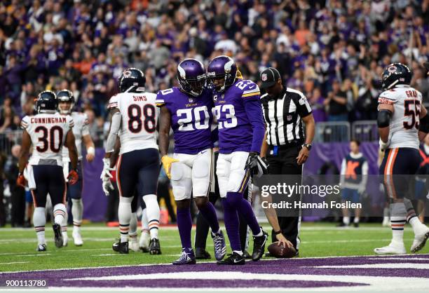 Mackensie Alexander of the Minnesota Vikings celebrates with teammate Terence Newman turning over the Chicago Bears in the fourth quarter of the game...