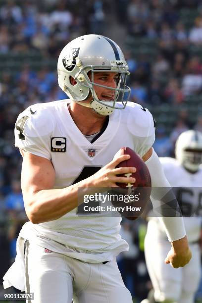 Derek Carr of the Oakland Raiders scrambles out of the pocket during the first quarter of the game against the Los Angeles Chargers at StubHub Center...