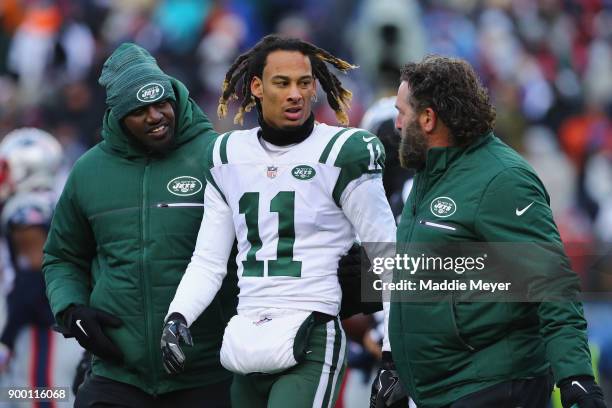 Robby Anderson of the New York Jets is helped off the field after suffering an injury during the second half against the New England Patriots at...