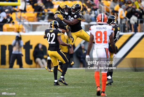 Tyson Alualu of the Pittsburgh Steelers celebrates with Vince Williams and William Gay after a sack on DeShone Kizer of the Cleveland Browns in the...