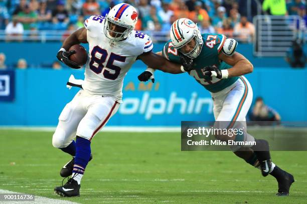 Charles Clay of the Buffalo Bills stiff arms Kiko Alonso of the Miami Dolphins during the first quarter at Hard Rock Stadium on December 31, 2017 in...