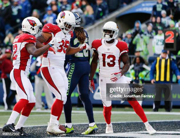 Running back Elijhaa Penny of the Arizona Cardinals celebrates his 4 yard touchdown in the second quarter against the Seattle Seahawks with John...