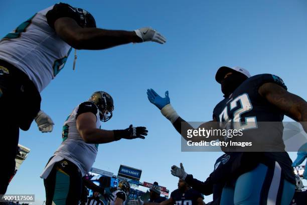 Tight End Delanie Walker of the Tennessee Titans shakes a Jacksonville Jaguars captain before their game at Nissan Stadium on December 31, 2017 in...