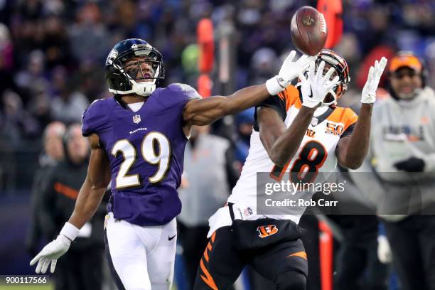 Wide Receiver A.J. Green of the Cincinnati Bengals catches a pass while defended by defensive back Marlon Humphrey of the Baltimore Ravens in the...