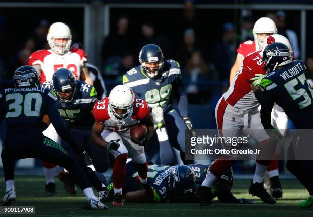 Running back Kerwynn Williams of the Arizona Cardinals rushes against the Seattle Seahawks in the first half at CenturyLink Field on December 31,...