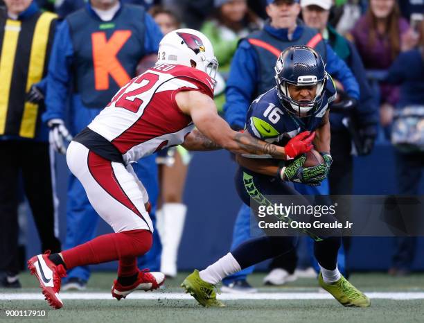 Tyler Lockett of the Seattle Seahawks is tackled by safety Tyrann Mathieu of the Arizona Cardinals at CenturyLink Field on December 31, 2017 in...