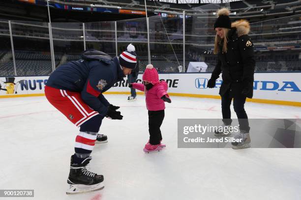 Michael Grabner of the New York Rangers skates with his family after practice for the 2018 Bridgestone NHL Winter Classic at Citi Field on December...