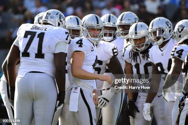 Derek Carr of the Oakland Raiders reacts after being sacked during the second quarter of the game against the Los Angeles Chargers at StubHub Center...