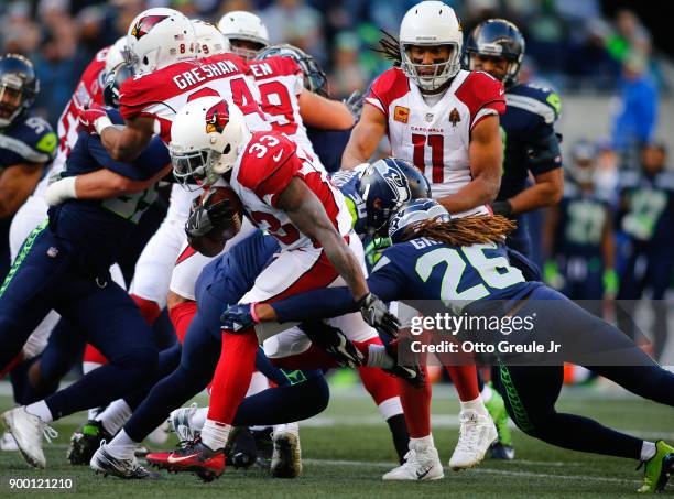 Running back Kerwynn Williams of the Arizona Cardinals rushes as he's tackled by cornerback Shaquill Griffin of the Seattle Seahawks in the first...