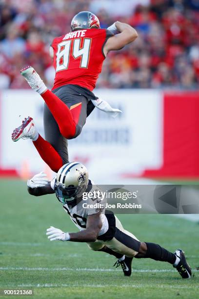 Ken Crawley of the New Orleans Saints trips up Cameron Brate of the Tampa Bay Buccaneers after a catch in the first quarter of a game at Raymond...