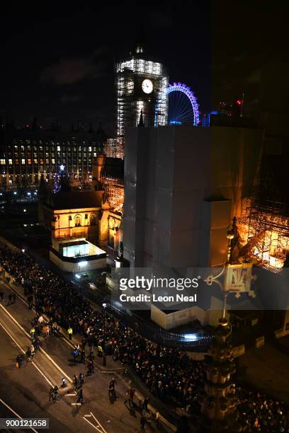 Scaffolding covers Big Ben while crowds queue to get into the waterside position to watch the fireworks show to ring in the near year on December 31,...