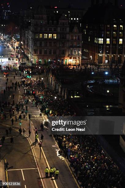 Crowds queue at Parliament Square to watch the fireworks show to ring in the near year on December 31, 2017 in London, England. Crowds are lining the...