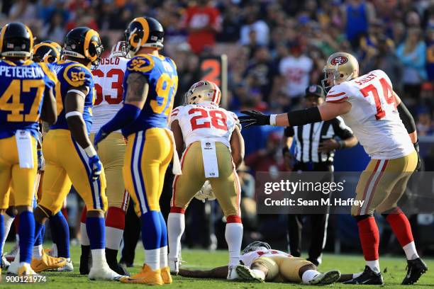 Carlos Hyde and Joe Staley rush to the aid of Marquise Goodwin of the San Francisco 49ers after he was injured on a play involving Blake Countess of...