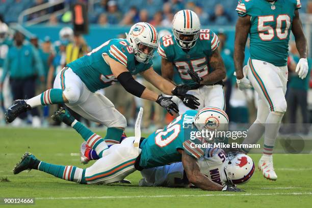 Reshad Jones of the Miami Dolphins tackles Marcus Murphy of the Buffalo Bills during the second quarter at Hard Rock Stadium on December 31, 2017 in...