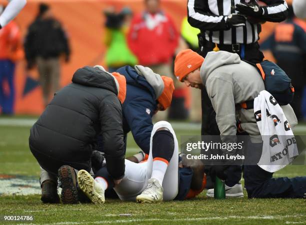 Denver Broncos medical staff checks on running back C.J. Anderson during an injury timeout against the Kansas City Chiefs in the first quarter on...