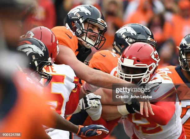 Denver Broncos quarterback Paxton Lynch throws a pass downfield after getting pressured by the Kansas City Chiefs defense during the first quarter on...
