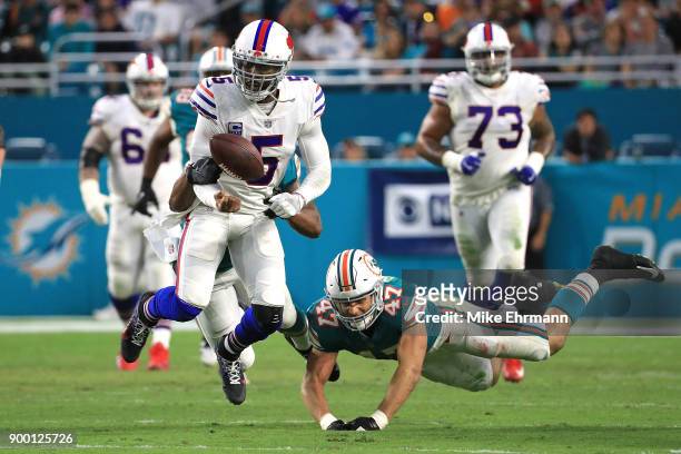 Stephone Anthony of the Miami Dolphins forces a fumble on Tyrod Taylor of the Buffalo Bills during the second quarter against the Miami Dolphins at...