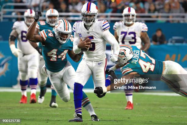 Stephone Anthony of the Miami Dolphins forces a fumble on Tyrod Taylor of the Buffalo Bills during the second quarter against the Miami Dolphins at...
