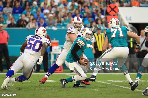 David Fales of the Miami Dolphins scrambling out the pocket during the second quarter against the Buffalo Bills at Hard Rock Stadium on December 31,...