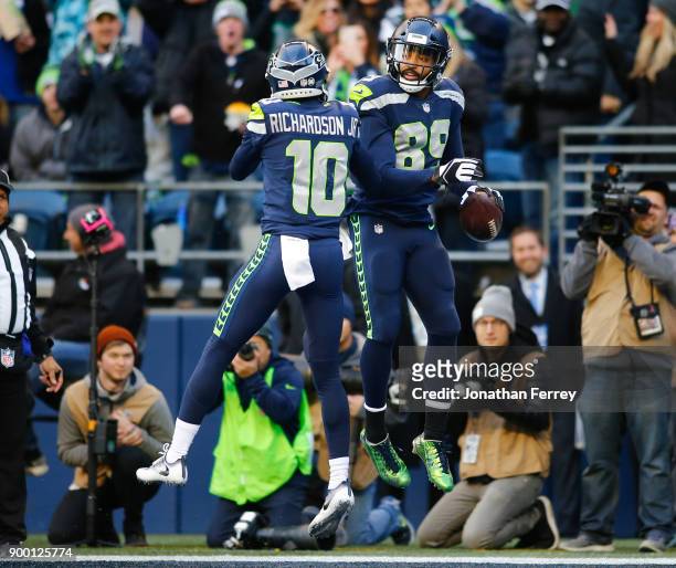 Wide receiver Doug Baldwin of the Seattle Seahawks celebrates his 18 yard touchdown with Paul Richardson during the third quarter of the game against...