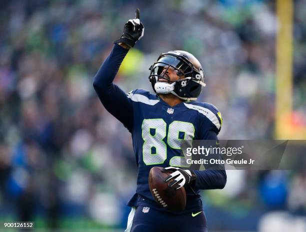 Wide receiver Doug Baldwin of the Seattle Seahawks points to the sky after scoring an 18 yard touchdown during the game against the Arizona Cardinals...