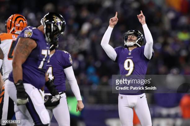 Kicker Justin Tucker of the Baltimore Ravens celebrates after kicking an extra point in the third quarter against the Cincinnati Bengals at M&T Bank...