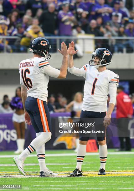 After hitting a 55-yard field goal Chicago Bears Place Kicker Mike Nugent high fives his placeholder Chicago Bears Punter Pat O'Donnell during a NFL...