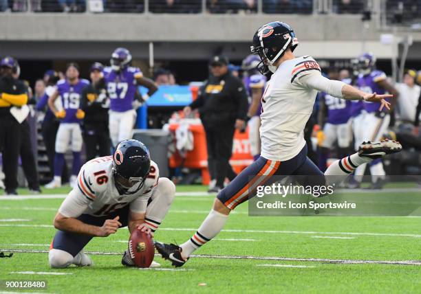 Chicago Bears Place Kicker Mike Nugent kicks an extra point with Chicago Bears Punter Pat O'Donnell on the hold during a NFL game between the...