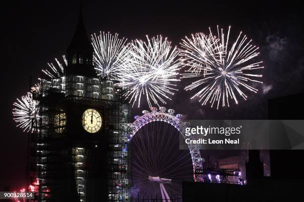 Fireworks explode over Big Ben as thousands gather to ring in the near year on January 1, 2018 in London, England. Crowds lined the banks of the...