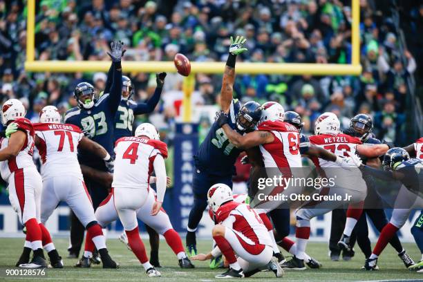 Kicker Phil Dawson of the Arizona Cardinals makes a 53 yard field goal as defensive end Dwight Freeney of the Seattle Seahawks, Bradley McDougald and...