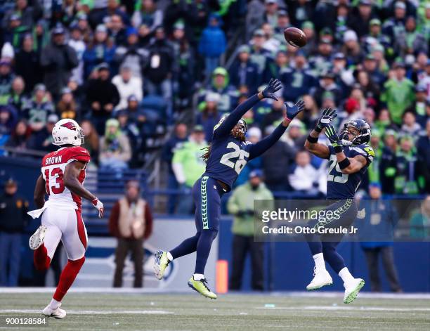 Cornerback Shaquill Griffin of the Seattle Seahawks and Earl Thomas prepare to intercept the ball from Quarterback Drew Stanton of the Arizona...