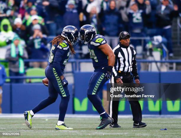 Shaquill Griffin of the Seattle Seahawks celebrates his interception with Bobby Wagner in the second half against the Arizona Cardinals at...