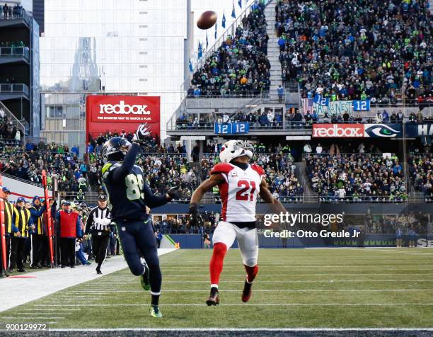 Wide receiver Doug Baldwin of the Seattle Seahawks brings in a 29 yard pass from Russell Wilson against cornerback Patrick Peterson of the Arizona...