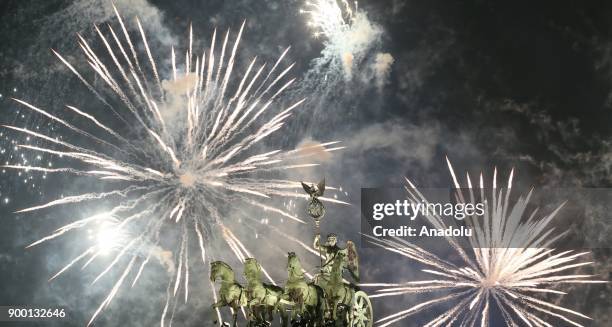 Fireworks light up the sky over Brandenburg Gate during the new year celebrations in Berlin, Germany on January 01, 2018.