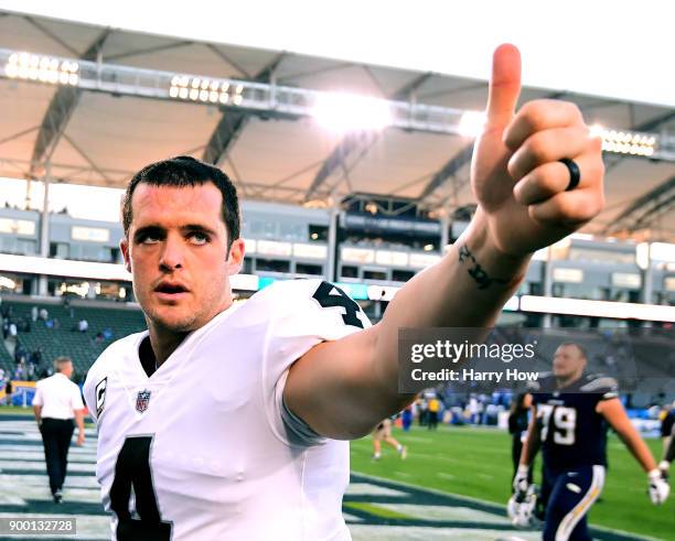 Derek Carr of the Oakland Raiders reacts as he leaves the field after 30-10 loss to the Los Angeles Chargers at StubHub Center on December 31, 2017...