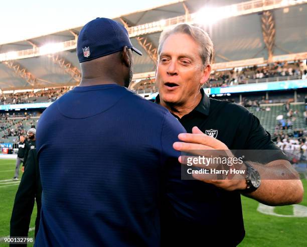 Head coach Jack Del Rio of the Oakland Raiders meets head coach Anthony Lynn of the Los Angeles Chargers after a 30-10 Charger win during the first...
