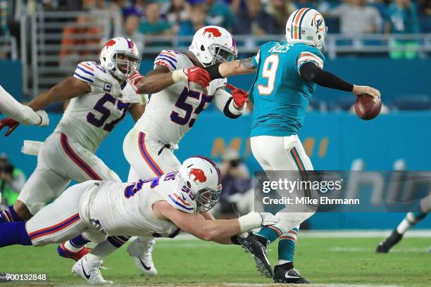 Quarterback David Fales of the Miami Dolphins is pressured during the fourth quarter against the Buffalo Bills at Hard Rock Stadium on December 31,...