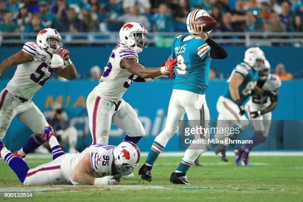 Quarterback David Fales of the Miami Dolphins is pressured during the fourth quarter against the Buffalo Bills at Hard Rock Stadium on December 31,...