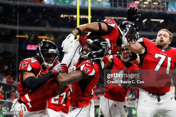 Robert Alford of the Atlanta Falcons celebrates with Desmond Trufant after an interception to end the game against the Carolina Panthers at...